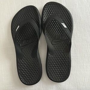 Nike black flip flops. New in box.